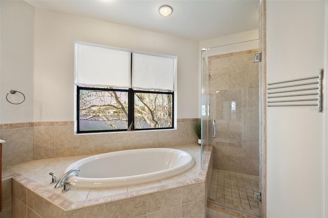 full bathroom featuring a stall shower and a garden tub