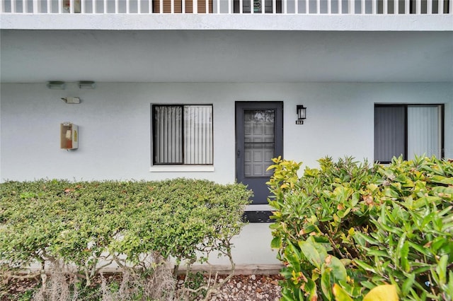 doorway to property with stucco siding