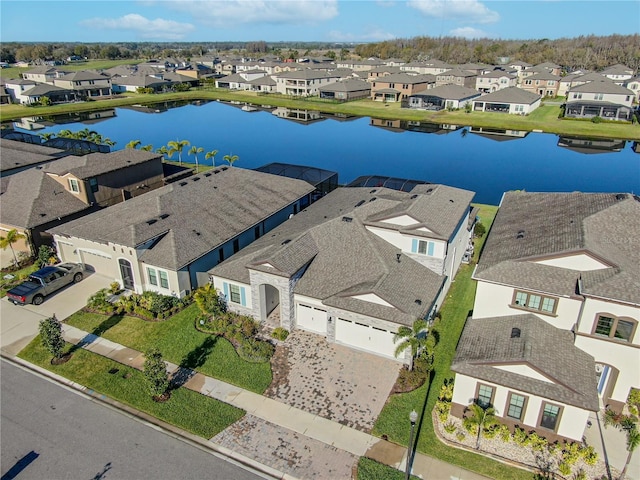 bird's eye view featuring a water view and a residential view