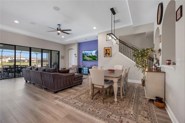 living area featuring stairs, recessed lighting, baseboards, and wood finished floors