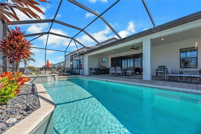 outdoor pool with a patio area, ceiling fan, glass enclosure, and outdoor dining area