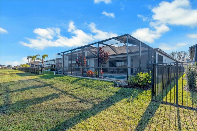 rear view of house featuring a yard, an outdoor pool, glass enclosure, and fence