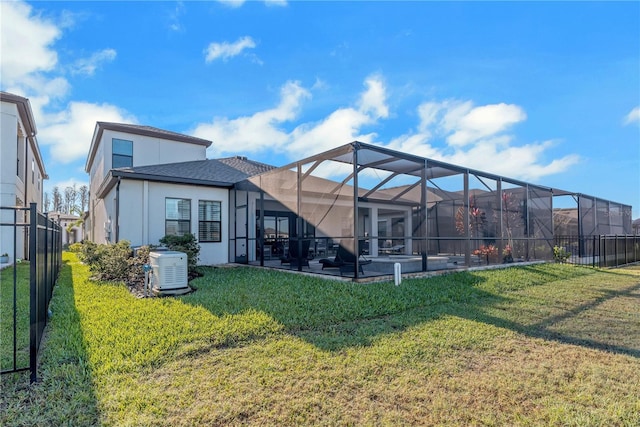 back of property featuring a lanai, stucco siding, a lawn, and a patio