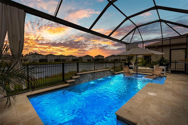 view of pool with a fenced in pool, glass enclosure, a residential view, fence, and a patio area