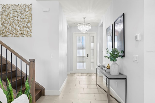 entryway featuring light tile patterned floors, stairway, baseboards, and a notable chandelier