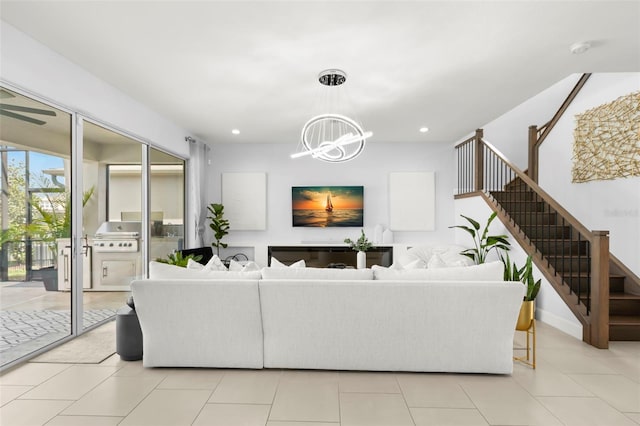 living room with recessed lighting, light tile patterned floors, a notable chandelier, and stairs