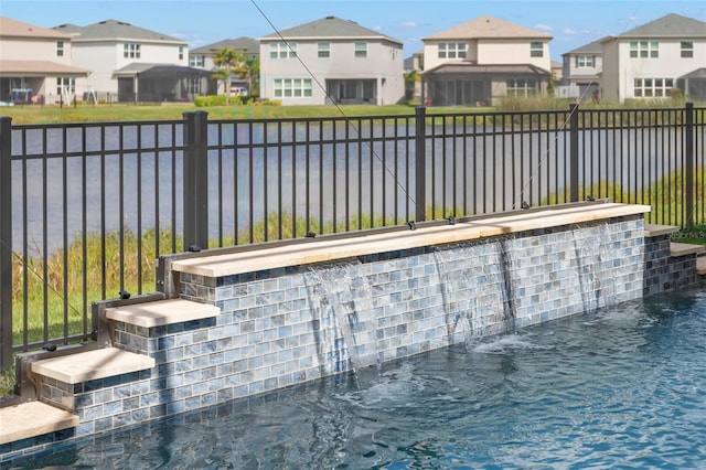 view of patio with a water view, a fenced backyard, and a residential view