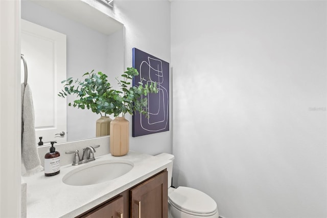 bathroom with toilet and vanity