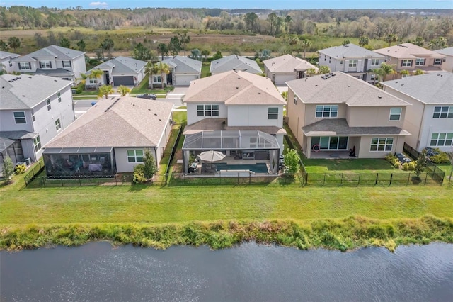 drone / aerial view featuring a residential view and a water view