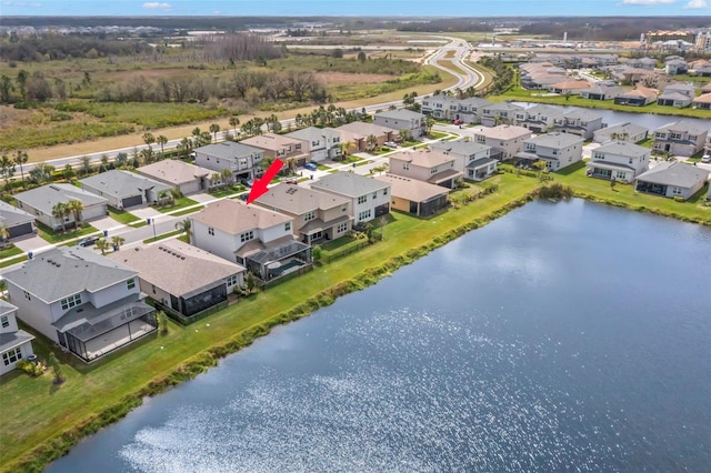 drone / aerial view featuring a water view and a residential view