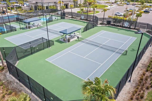 view of sport court featuring a residential view and fence