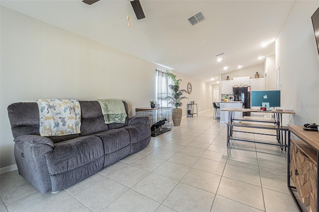 living room featuring lofted ceiling, ceiling fan, light tile patterned floors, and visible vents