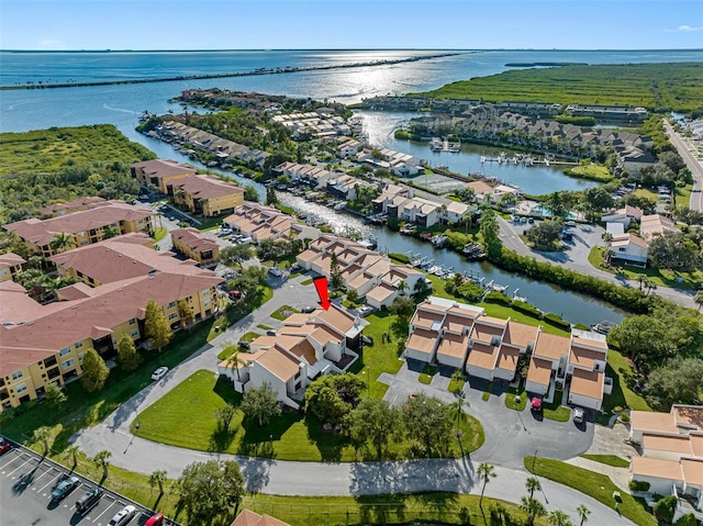 drone / aerial view featuring a water view and a residential view