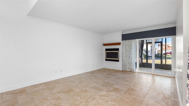 unfurnished living room featuring ornamental molding, a fireplace, and baseboards