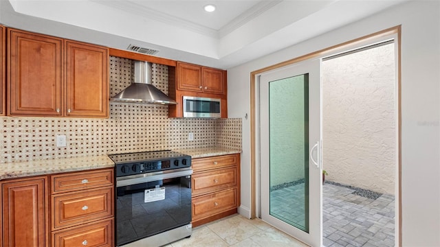 kitchen with range with electric cooktop, visible vents, wall chimney range hood, tasteful backsplash, and stainless steel microwave