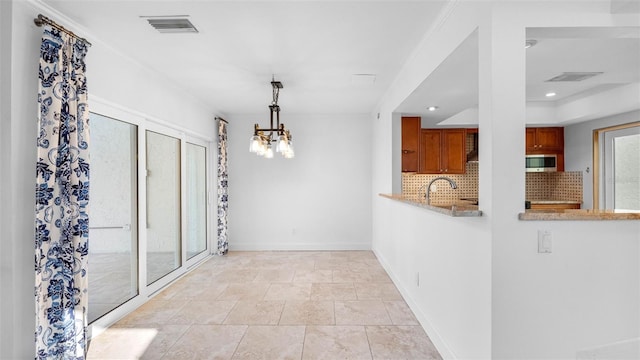 interior space featuring a chandelier, recessed lighting, a sink, visible vents, and baseboards