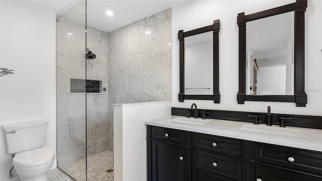 full bathroom featuring toilet, double vanity, a walk in shower, and a sink