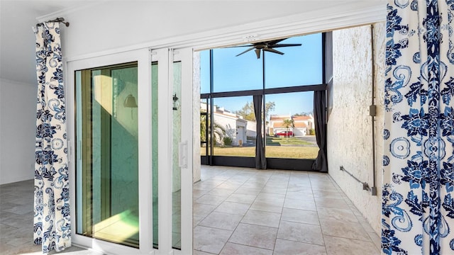 doorway to outside featuring a ceiling fan and light tile patterned floors