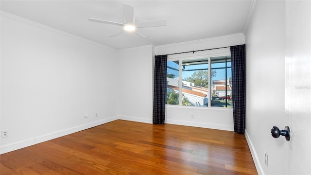 unfurnished room featuring ornamental molding, ceiling fan, baseboards, and wood finished floors