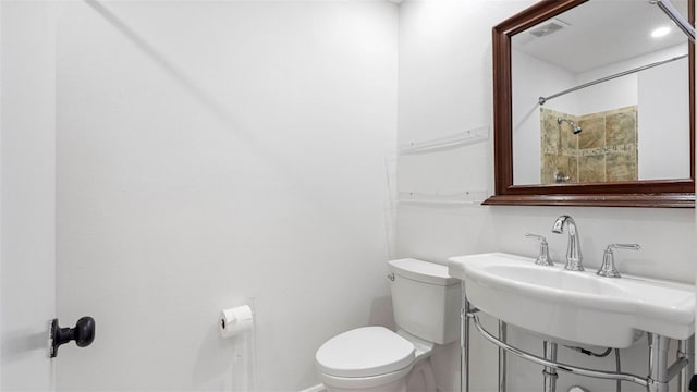 bathroom with visible vents, a sink, and toilet