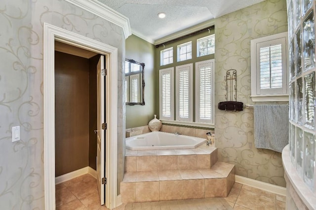 bathroom with wallpapered walls, a garden tub, plenty of natural light, and a textured ceiling