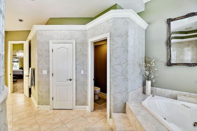 ensuite bathroom with wallpapered walls, ensuite bath, tile patterned flooring, a jetted tub, and toilet