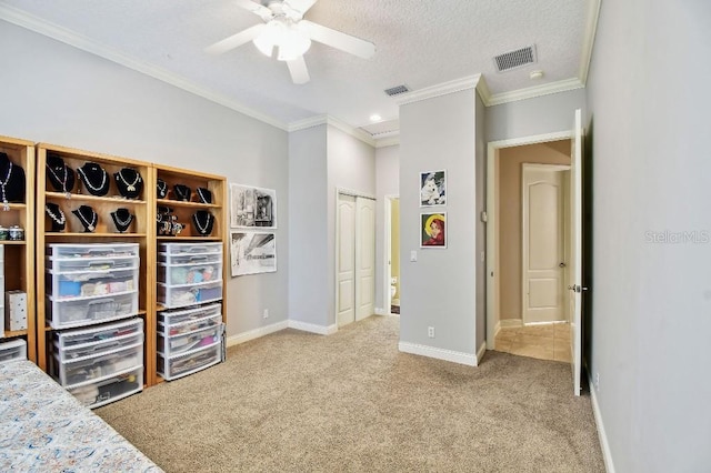 bedroom with crown molding, carpet flooring, baseboards, and visible vents