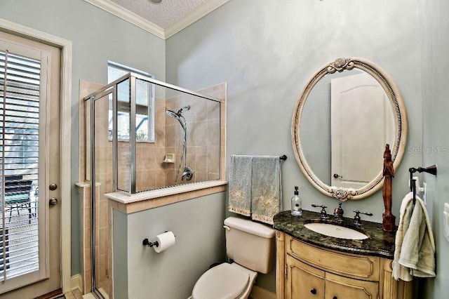 full bathroom featuring vanity, a shower stall, toilet, and ornamental molding