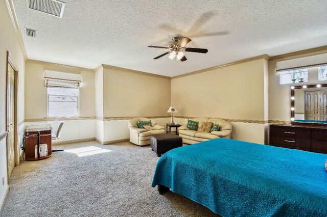 bedroom with visible vents, multiple windows, and carpet