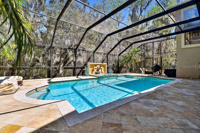 view of pool with glass enclosure, a patio area, and a pool with connected hot tub