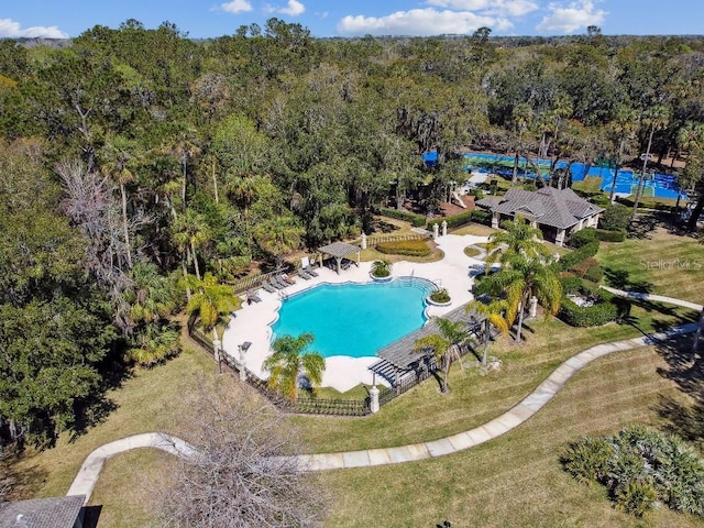 bird's eye view with a wooded view