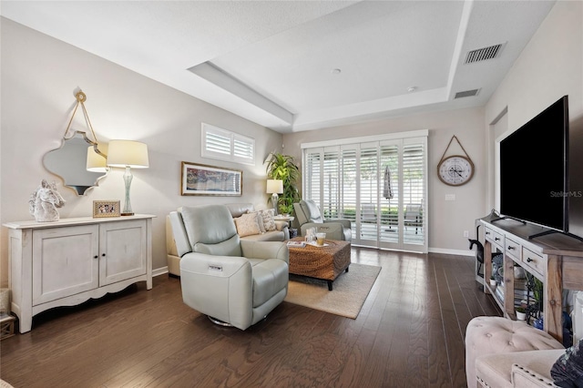 1467 Twin Villas Way, Dunedin, FL 34698 - living room featuring a tray ceiling, baseboards, and dark wood-style floors