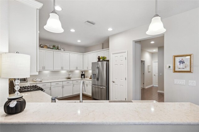 1467 Twin Villas Way, Dunedin, FL 34698 - kitchen featuring stainless steel fridge, white cabinets, stove, light stone counters, and recessed lighting