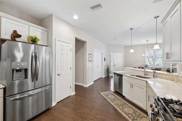 1467 Twin Villas Way, Dunedin, FL 34698 - kitchen featuring appliances with stainless steel finishes, a sink, white cabinetry, a peninsula, and recessed lighting