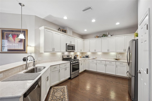 1467 Twin Villas Way, Dunedin, FL 34698 - kitchen with stainless steel appliances, a sink, white cabinets, dark wood-style flooring, and recessed lighting