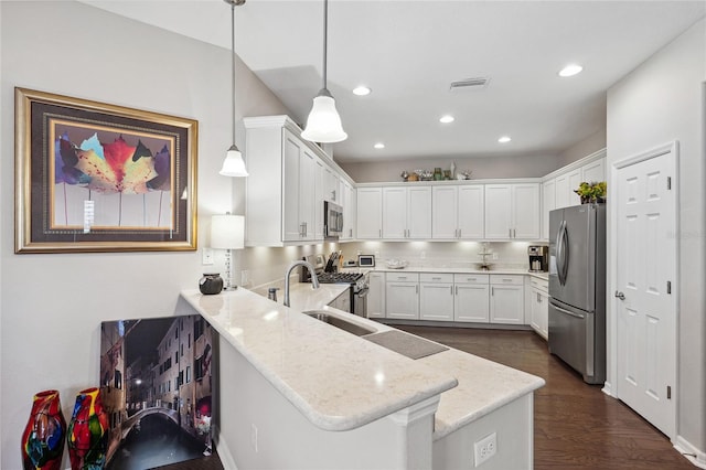 1467 Twin Villas Way, Dunedin, FL 34698 - kitchen featuring stainless steel appliances, white cabinets, a peninsula, and recessed lighting