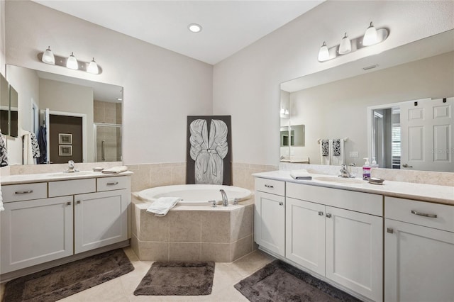 1467 Twin Villas Way, Dunedin, FL 34698 - full bathroom featuring a stall shower, a bath, tile patterned floors, and two vanities