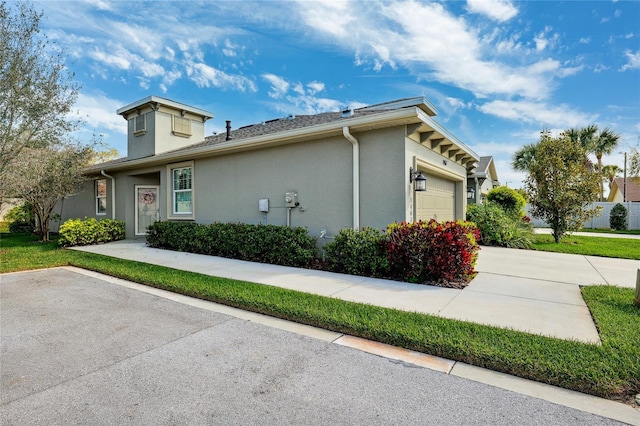 1467 Twin Villas Way, Dunedin, FL 34698 - view of property exterior with an attached garage and stucco siding