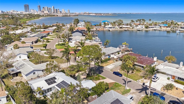 drone / aerial view featuring a water view and a view of city