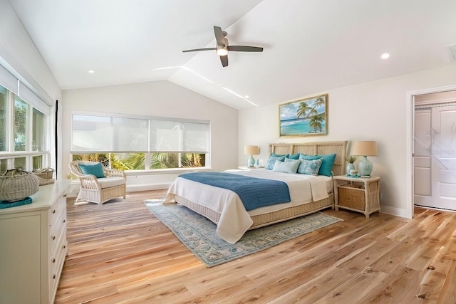 bedroom with light wood-type flooring, multiple windows, and vaulted ceiling