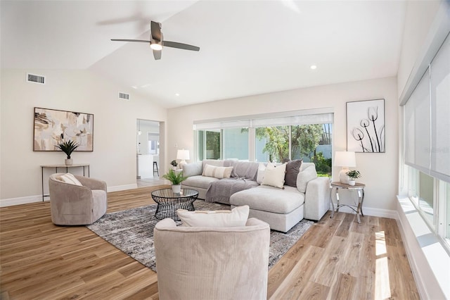 living area with vaulted ceiling, visible vents, light wood-style flooring, and baseboards