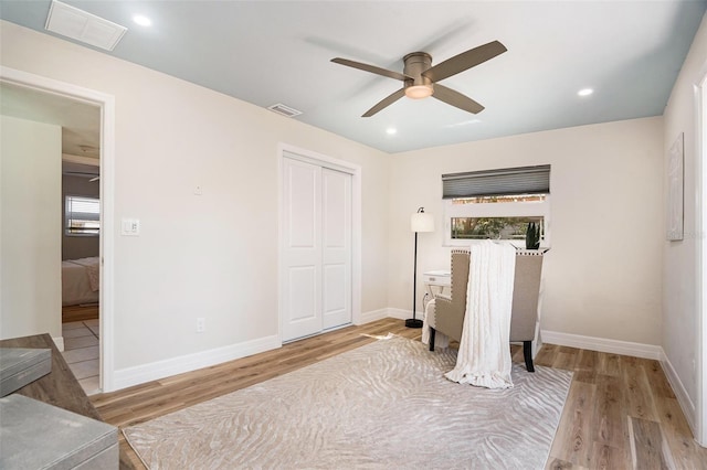 bedroom featuring visible vents, baseboards, and wood finished floors