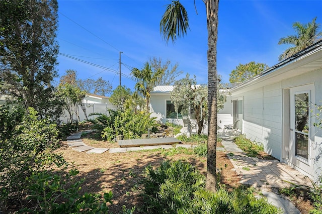 view of yard featuring fence and a vegetable garden