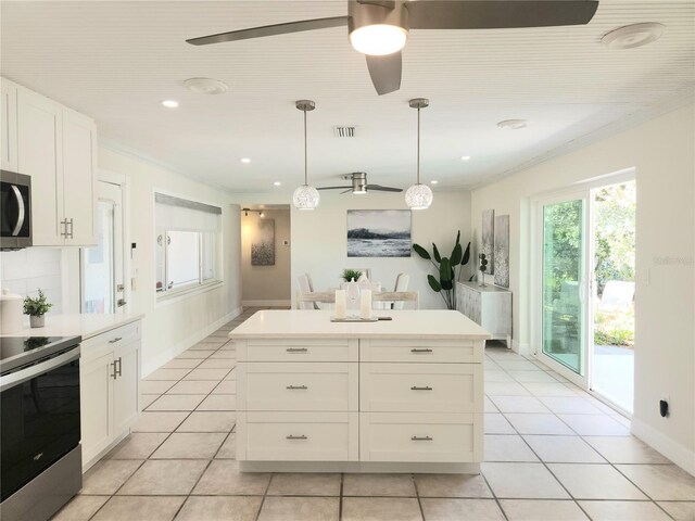 kitchen with white cabinetry, visible vents, ornamental molding, and stainless steel appliances