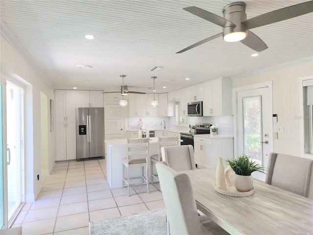 dining space with light tile patterned floors, ornamental molding, a ceiling fan, and recessed lighting