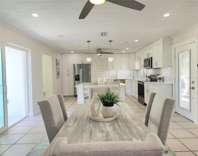 dining space with ornamental molding, recessed lighting, visible vents, and light tile patterned floors