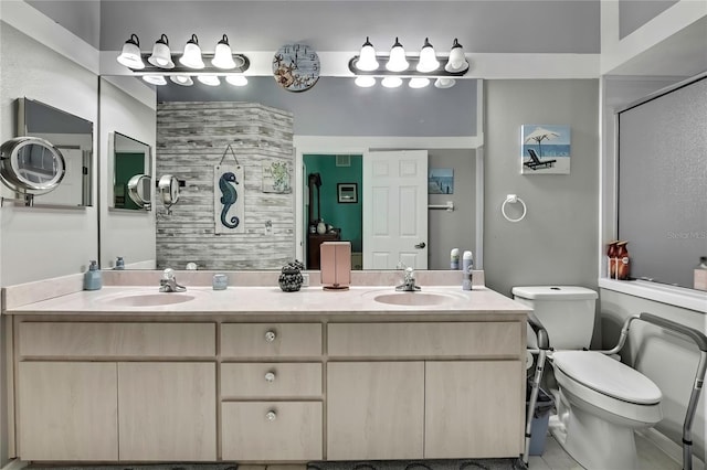 bathroom featuring toilet, a sink, and a shower with shower door