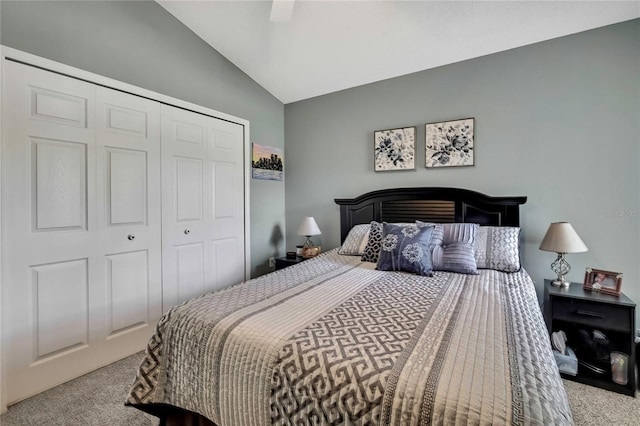 carpeted bedroom with a ceiling fan, vaulted ceiling, and a closet