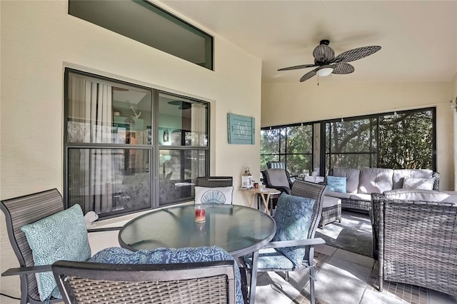 sunroom / solarium with lofted ceiling and a ceiling fan