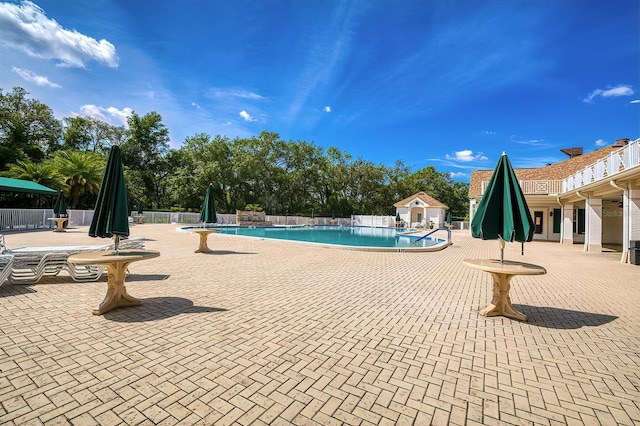 pool with fence and a patio